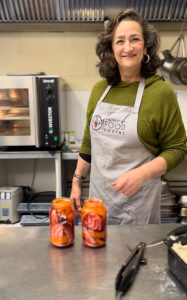 A volunteer with two jars of pickled beetroot