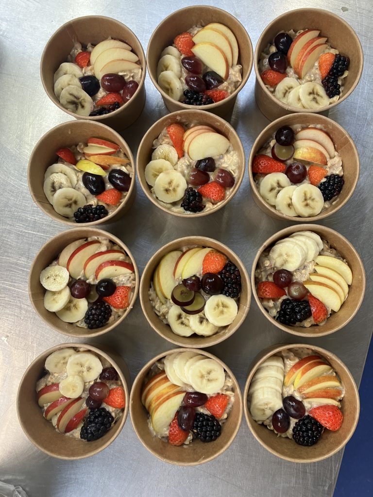 Tubs of overnight oats with fresh fruit